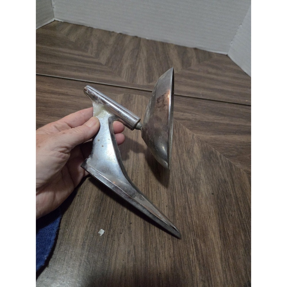 1950s-era streamlined chrome exterior side-view mirror with an aerodynamic...